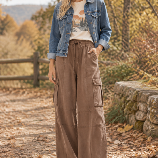 Brown Weekend Wanderer wide-leg cargo pants styled with a denim jacket, graphic tee, and fall baseball cap