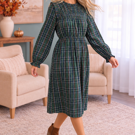 Green plaid midi dress styled with brown ankle boots and a soft brown suede hat