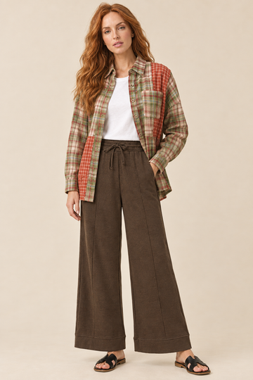 AI-styled outfit featuring espresso pintuck wide-leg pants with a mixed plaid color block shirt and white tee