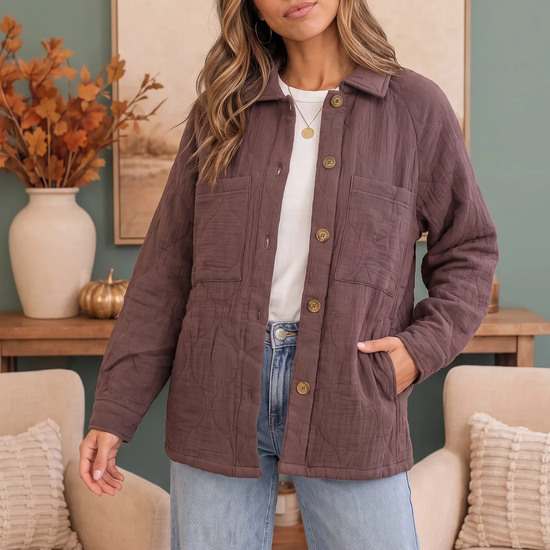 Woman wearing a mauve-brown quilted button-front jacket with chest pockets over a white top and light-wash jeans