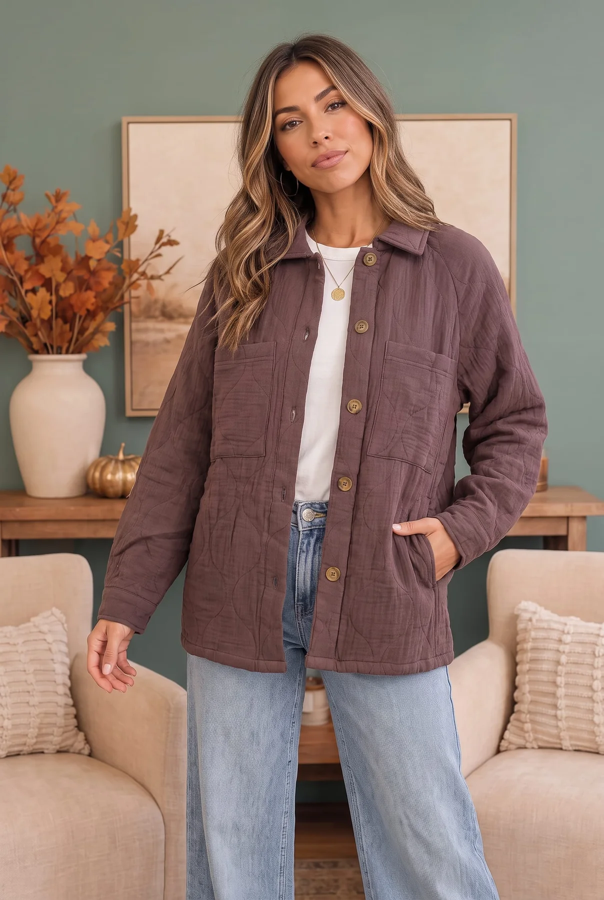 Woman wearing a mauve-brown quilted button-front jacket with chest pockets over a white top and light-wash jeans