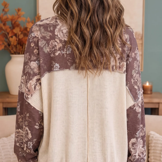 Back view of a mauve floral sweatshirt with a contrasting cream ribbed back panel, cuffs, and hem
