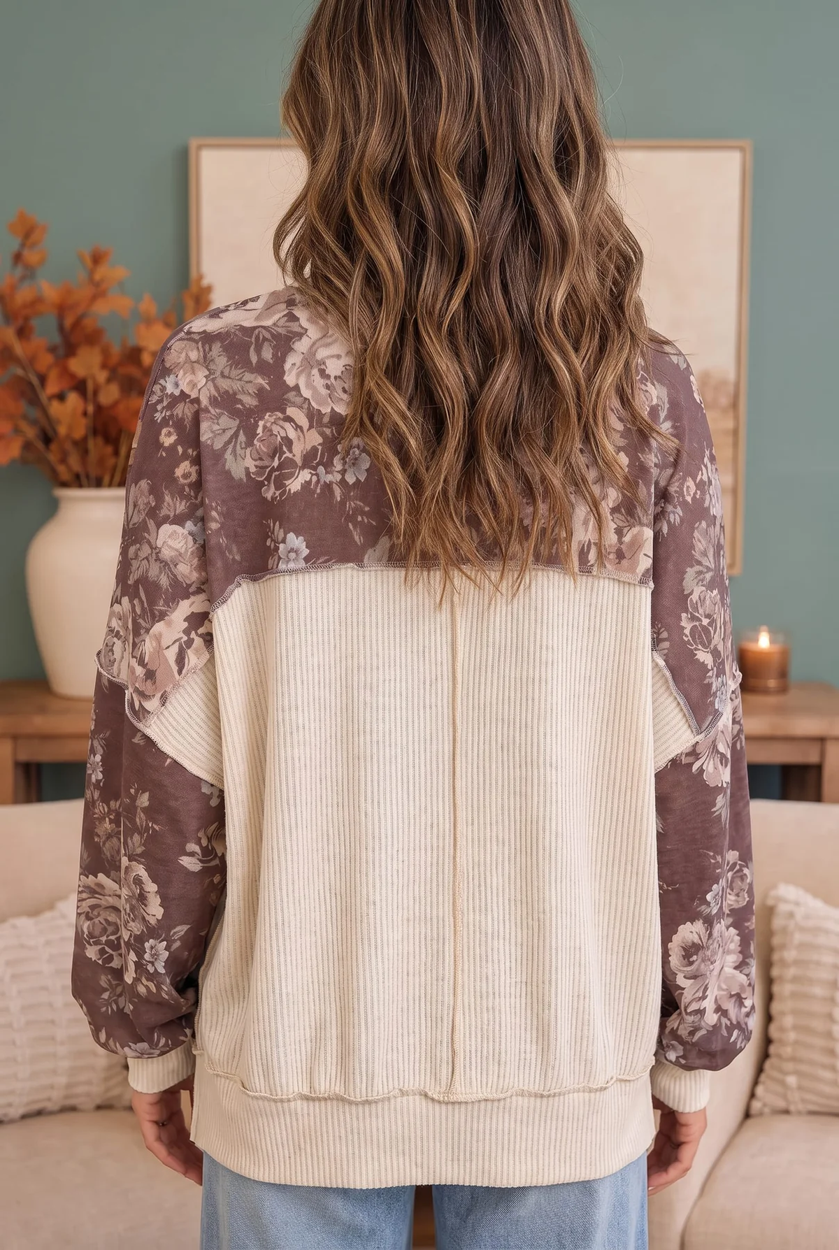 Back view of a mauve floral sweatshirt with a contrasting cream ribbed back panel, cuffs, and hem