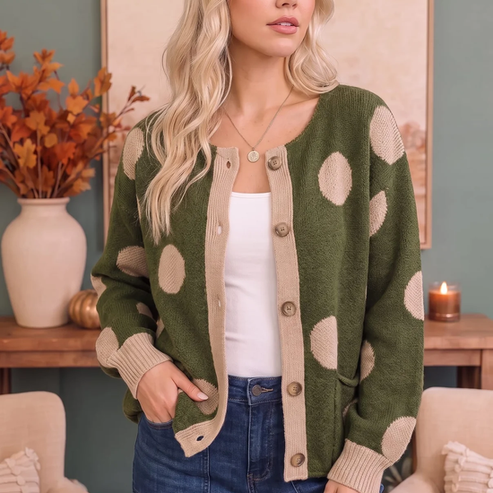 Front view of an olive button-front cardigan with cream polka dots, contrast trim, and pockets